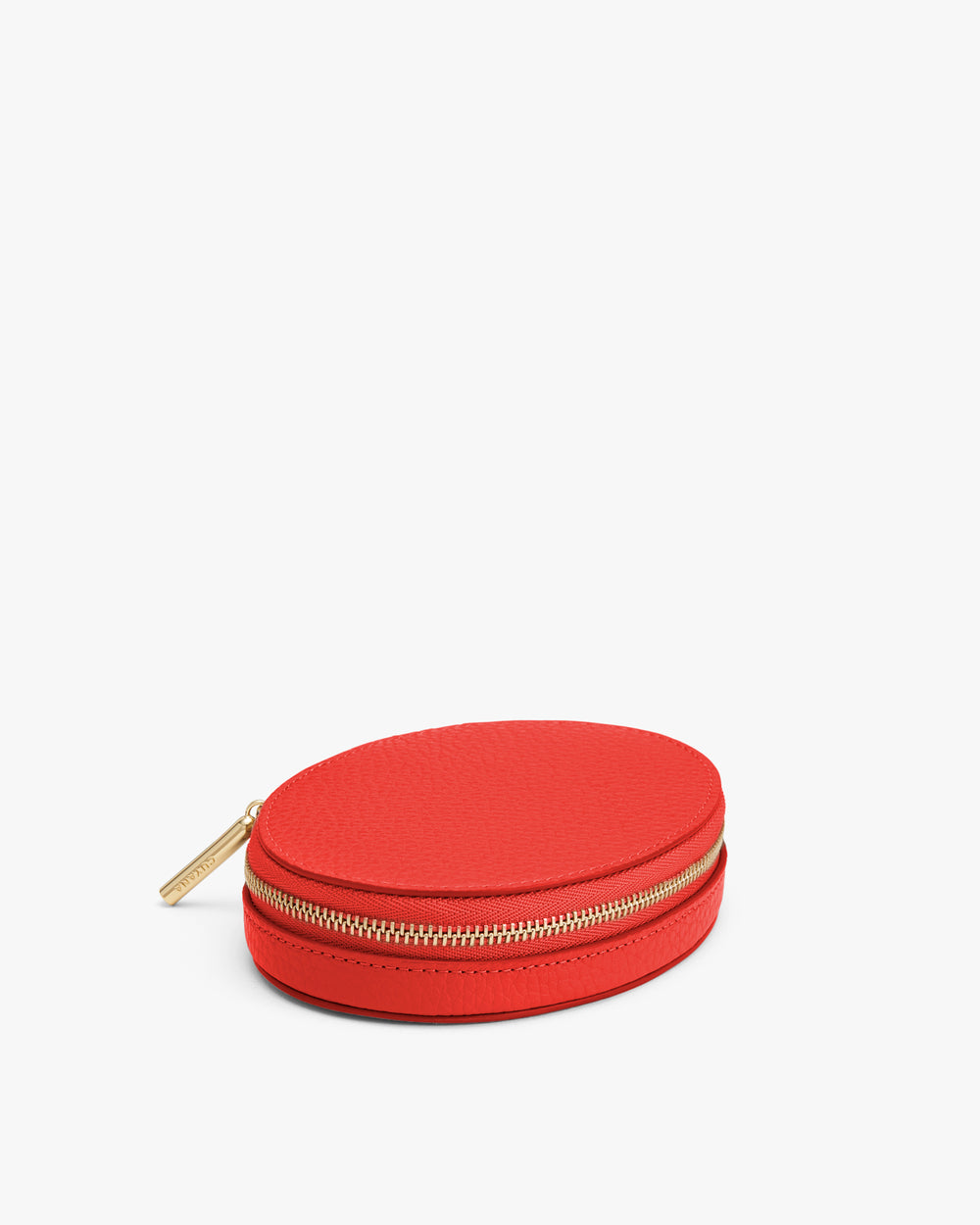 Round zippered case on a plain background.