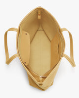 Open handbag with two internal pockets and a zipper closure.