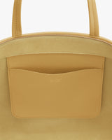Close-up of a tote bag with an inner pocket and zipper.