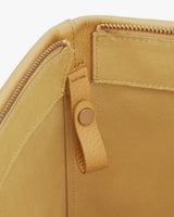 Open travel bag with a zipper and button closure detail inside.
