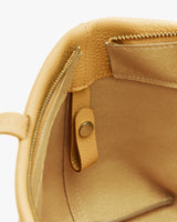 Open purse with zipper pocket and snap button inside.