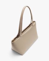Elegant handbag with two handles and a zip closure viewed from the top angle.