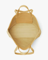 Looking down into an open tote bag with handles.