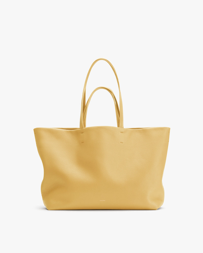 Large tote bag with two handles against plain background.