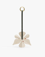 Flower-shaped keychain with a ring and strap attached.