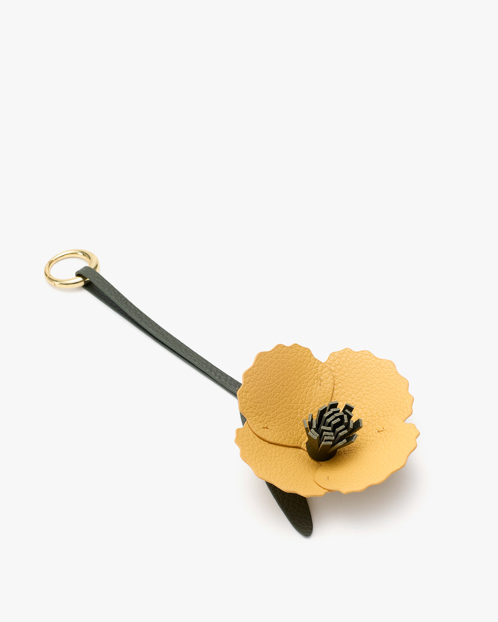 Flower-shaped leather keychain with a loop.