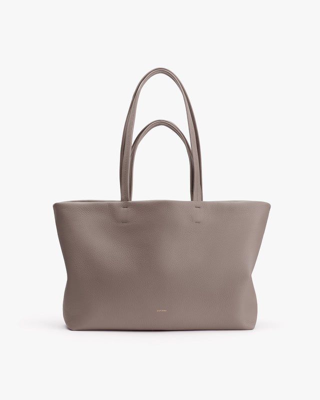 Tote bag with dual handles on a plain background