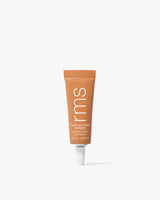 Small tube of cosmetics with a white cap on a plain background.