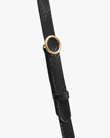 Croc-embossed leather strap with circular metal buckle.