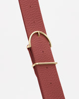 Wide textured belt with a gold buckle and loops.
