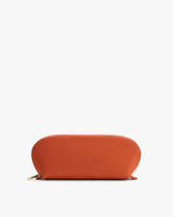 Oval-shaped zippered pouch on white background.