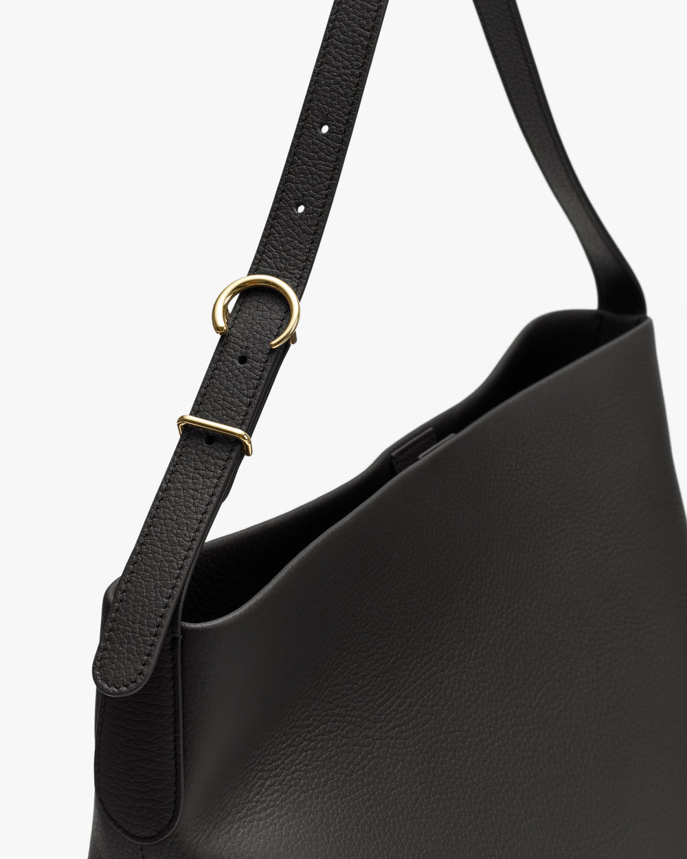 Shoulder bag with adjustable strap and metal ring detail.