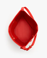 Top view of an open tote bag with a strap and a small pocket inside.