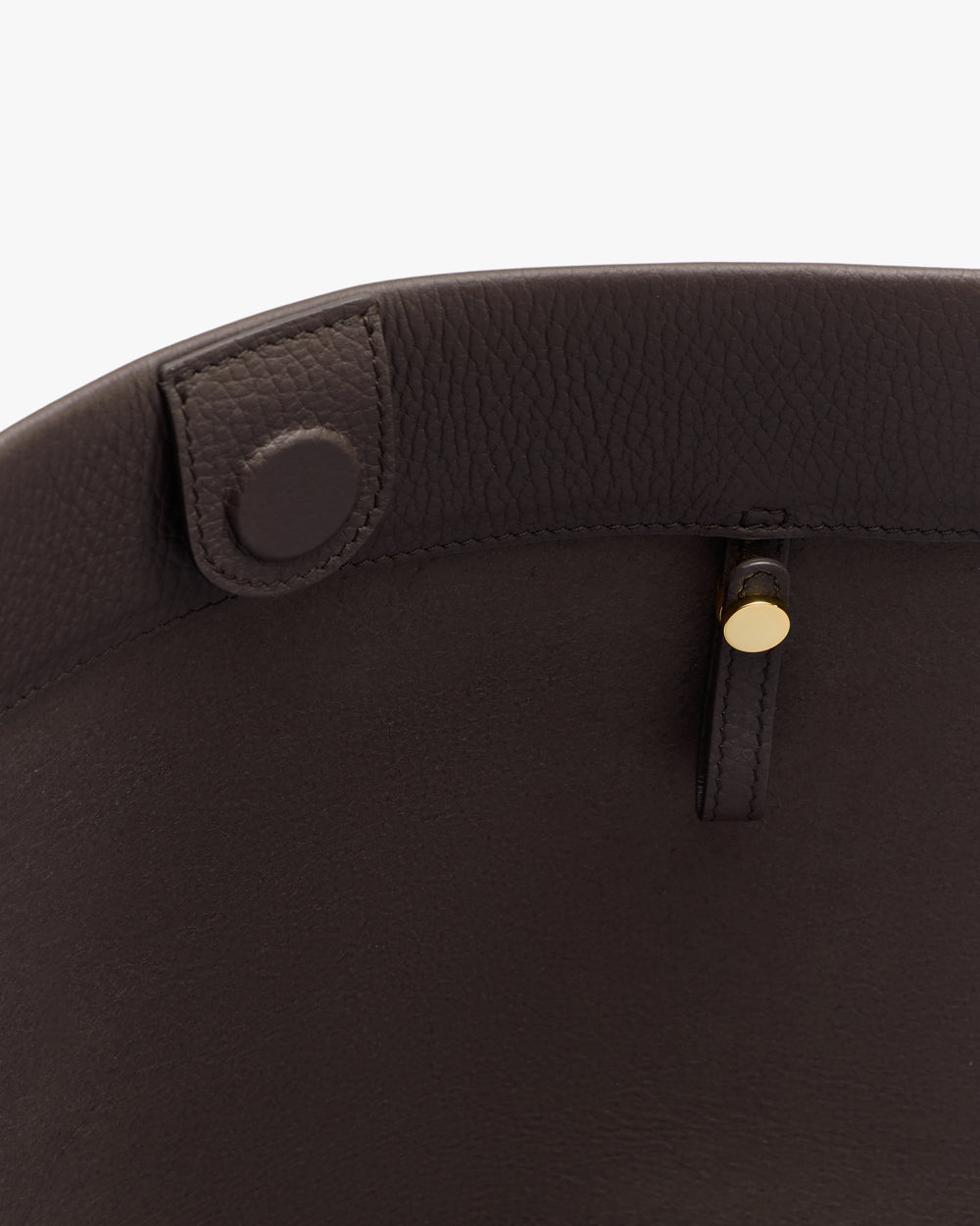 Close-up of a bag interior with a button and strap detail.