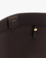 Close-up of a bag interior with a button and strap detail.