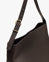 Shoulder bag with an adjustable strap and gold ring detail.