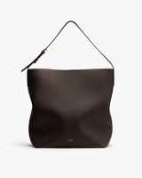 Shoulder bag with single strap and embossed surface.