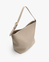 Bucket bag with a shoulder strap and gold buckle.