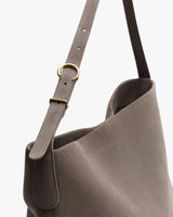 Shoulder bag with adjustable strap and gold buckle.