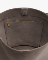 Open bag with an interior zippered pocket and snap closure.