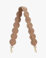 Bag strap with circular loops and metal clips.