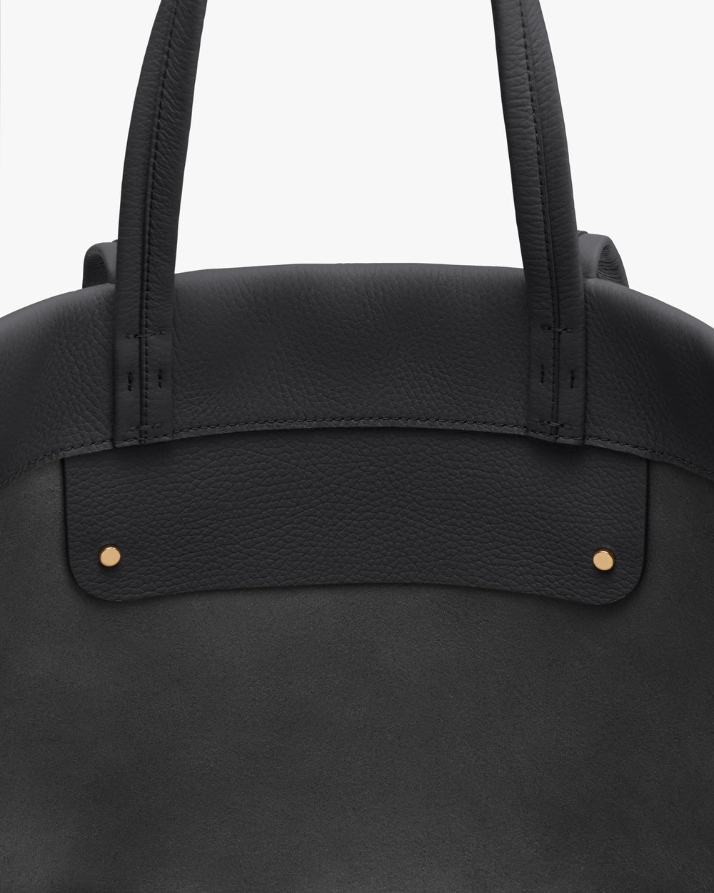 Close-up of a bag with two handles and small metal accents.