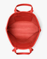 Open travel bag with handles, showing interior and pocket.