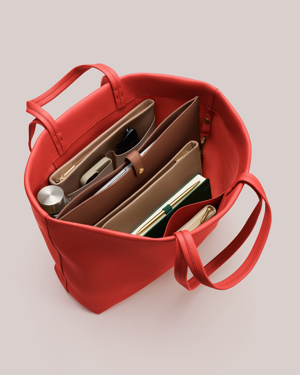 Open tote bag containing organized items like folders and a water bottle.