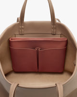 Open travel bag with a pocket insert inside.
