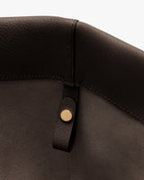 Close-up of a bag corner with a button detail.