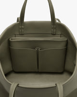 Open travel bag with interior pockets and handles.
