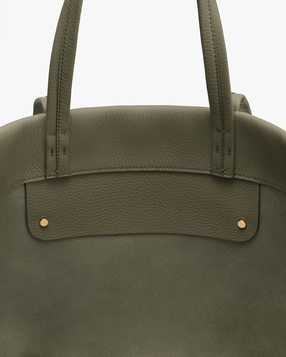 Close-up of a tote bag with two handles and metal rivets.