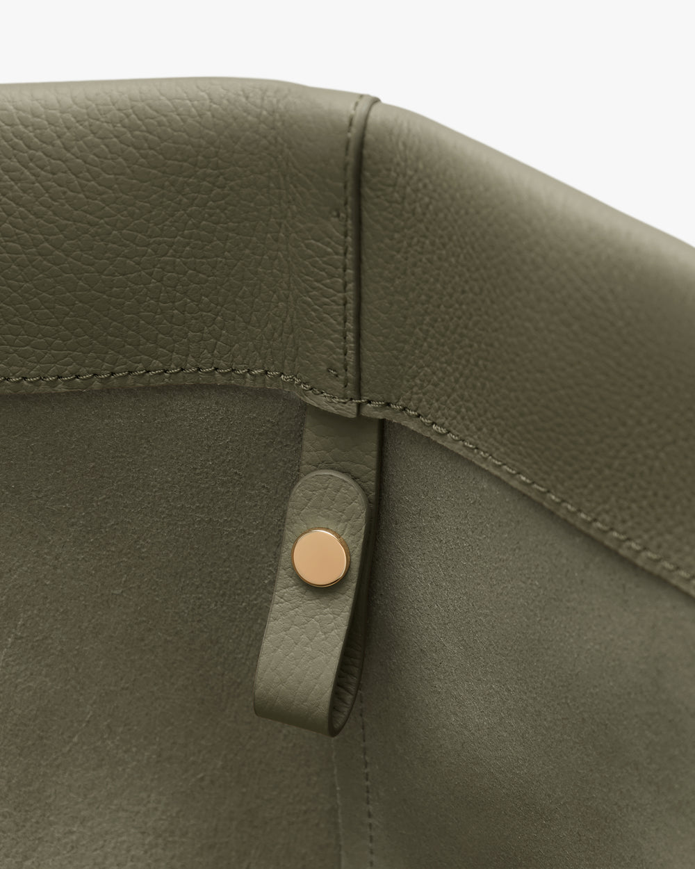 Close-up of a bag's interior with a button and strap.