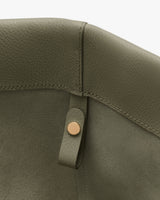 Close-up of a bag's interior with a button and strap.