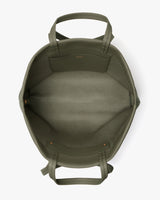 Open travel bag with dual handles positioned on flat surface.