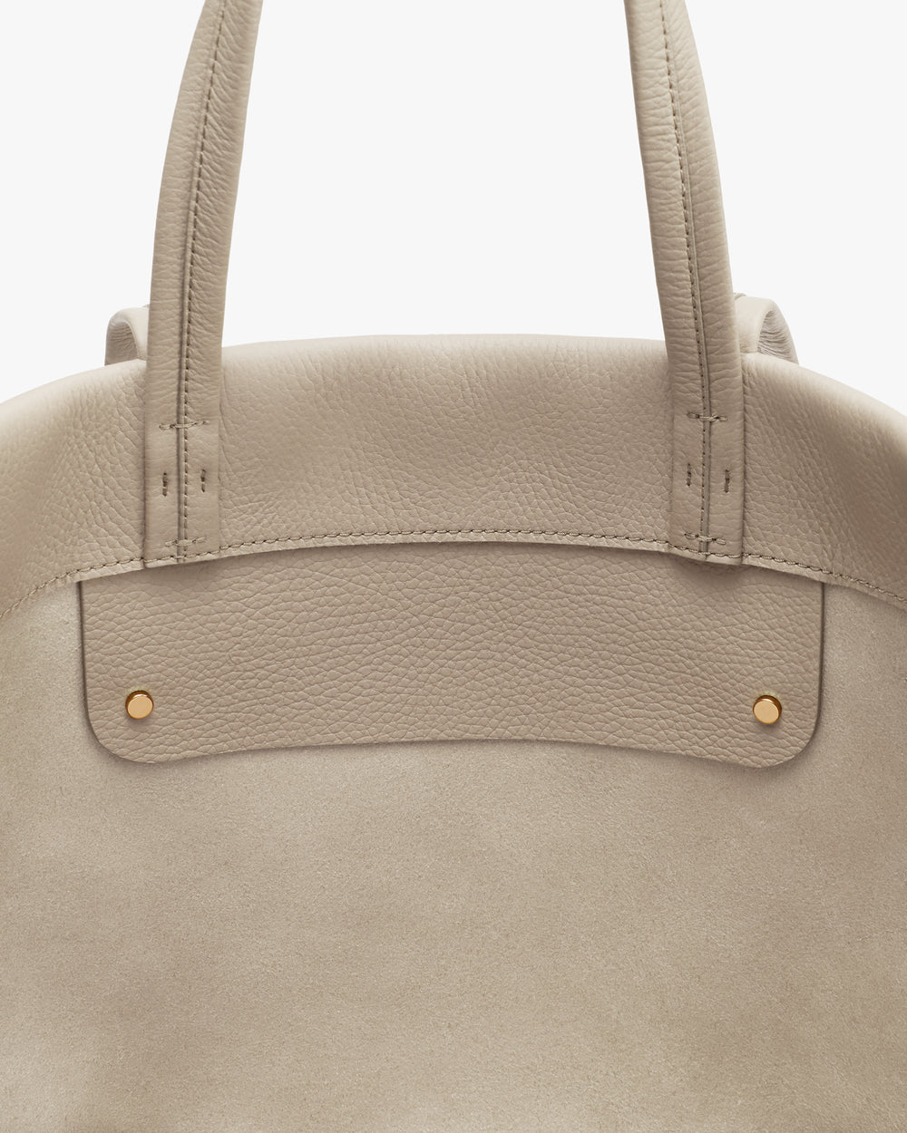 Tote bag with two handles and metal rivets.