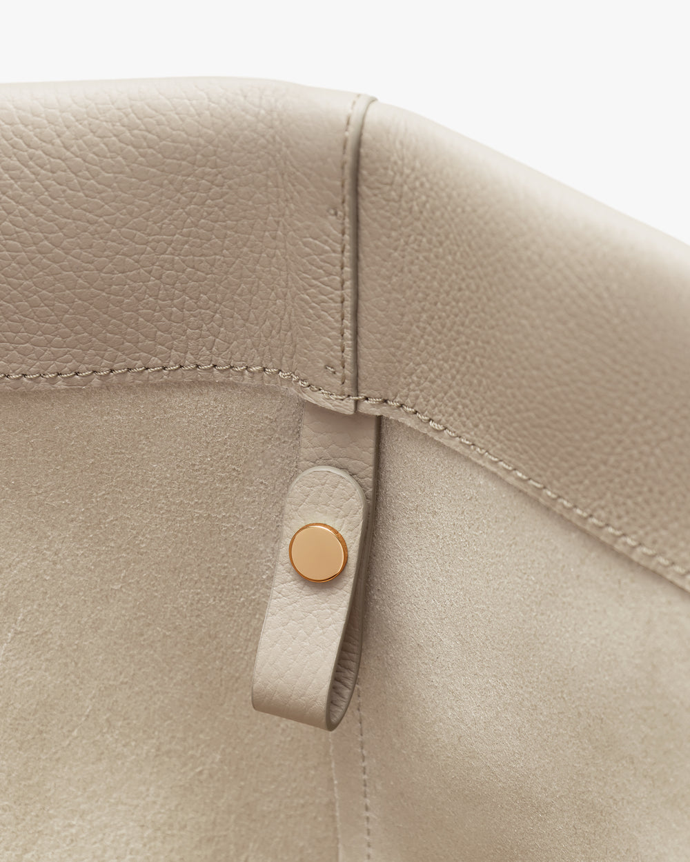 Close-up of leather corner with a button detail.