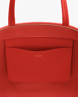 Tote bag with a zippered top and external pocket.