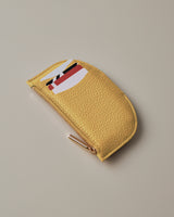 Small zippered pouch with a geometric design on top.