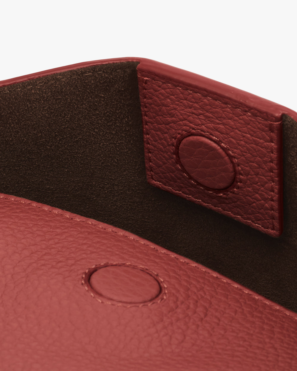 Close-up of a textured bag with magnetic closure flap.