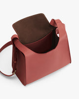 Open handbag with a shoulder strap and a front pocket.