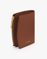 Compact wallet with zip and embossed brand logo.
