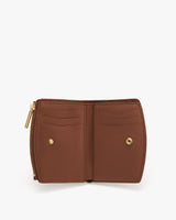 Open wallet with card slots and button closure.