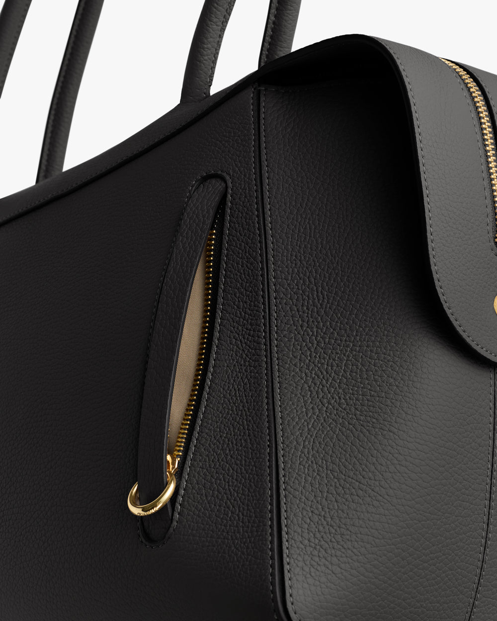 Close-up of a handbag with a zipper and handle details.