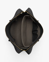 Open top view of an empty handbag with zippered edges.
