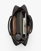 Open travel bag with various neatly organized items inside.