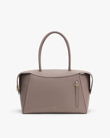 Elegant handbag with long handles and minimal design.