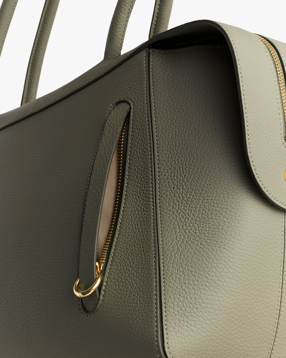 Close-up of a structured handbag with a visible zipper and handle.