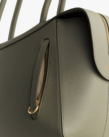 Close-up of a structured handbag with a visible zipper and handle.