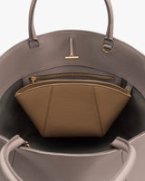 Open handbag with inner zippered pouch and metal clasp.